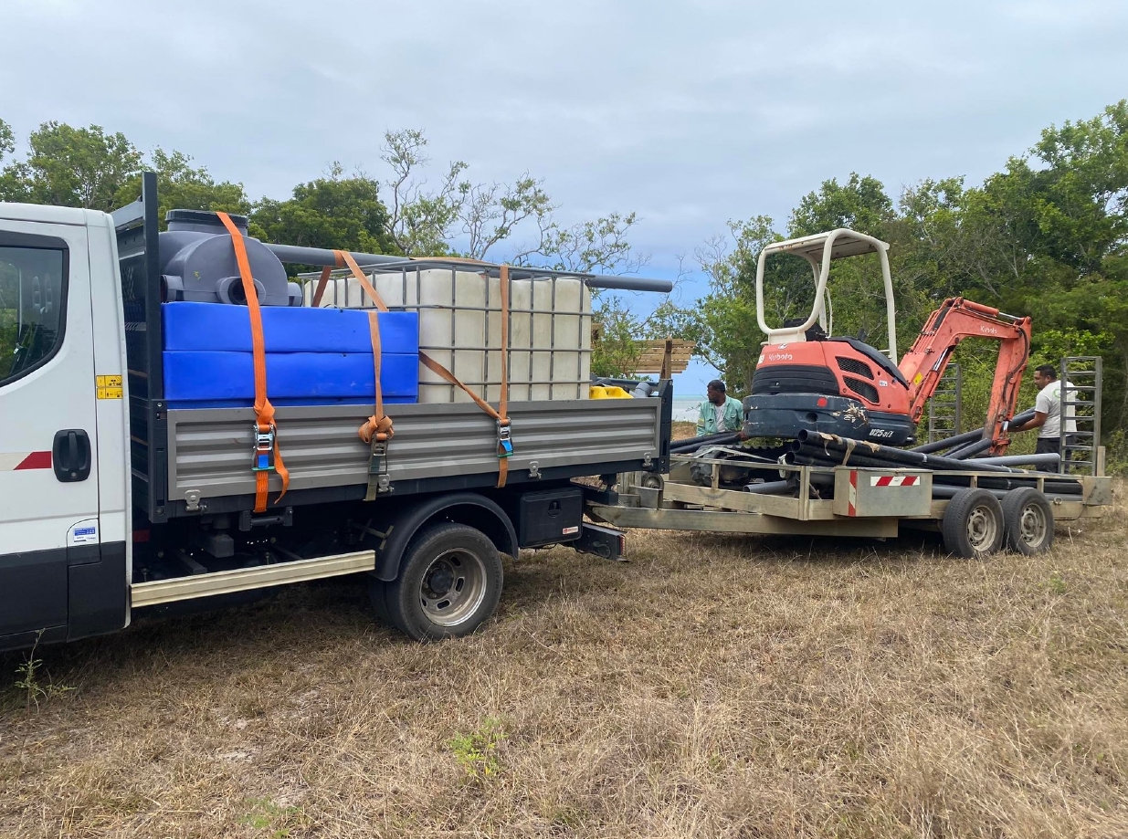 Camion et mini-pelle de l’Entreprise Quinty en intervention sur un chantier en Nouvelle-Calédonie, illustrant la logistique et la préparation du matériel pour les travaux publics et aménagements extérieurs.